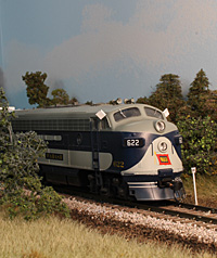Extra 622 East passes a tree farm