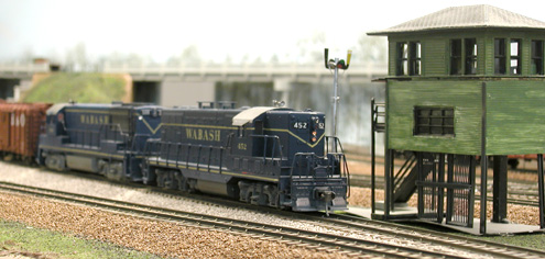 Extra 452 East passing the tower at Lafayette Jct